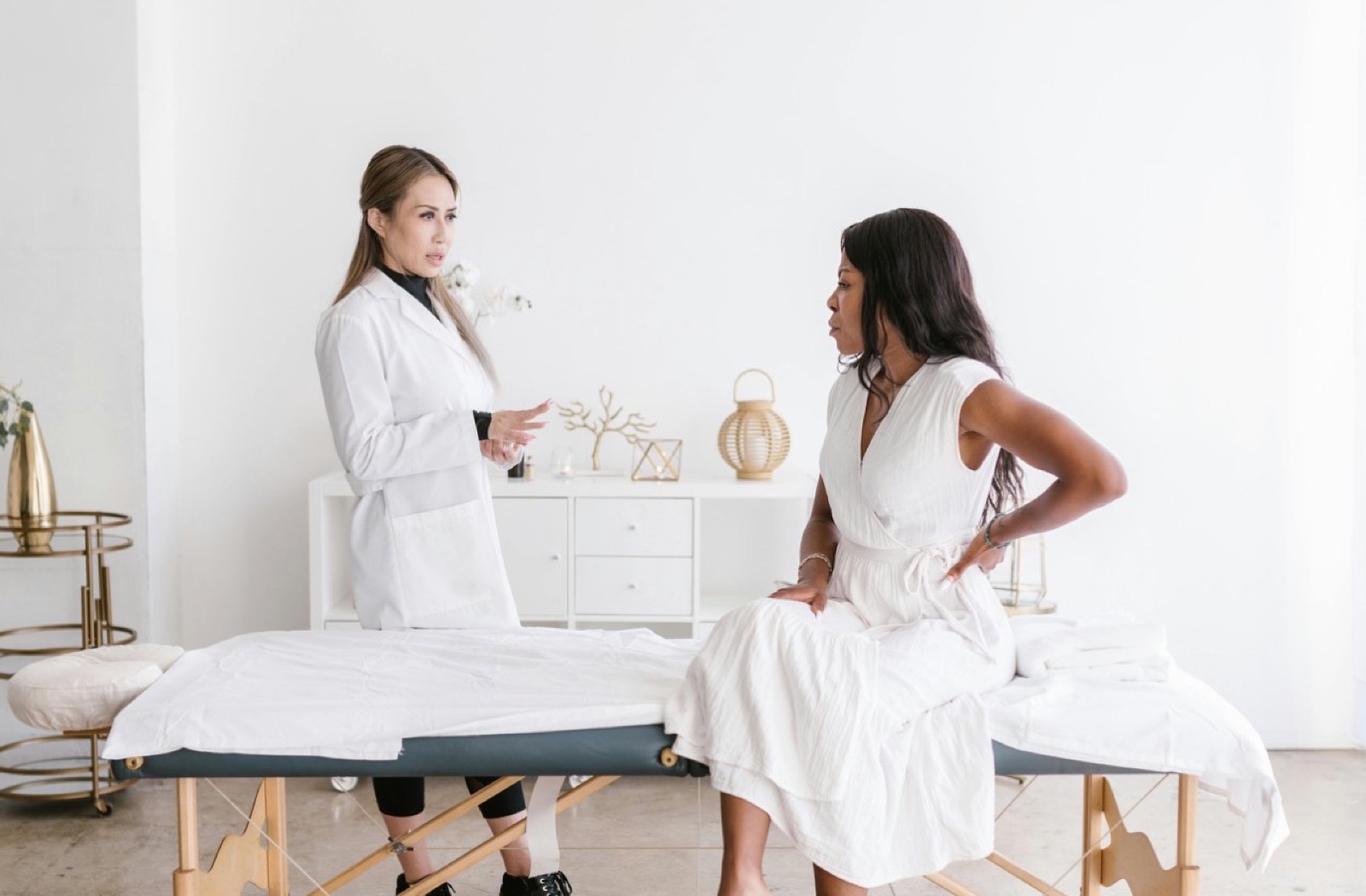 Consulta inicial con paciente y profesional sanitario en sala de exploracion.